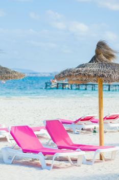 View of two chairs and umbrella on the beach. Vertical view