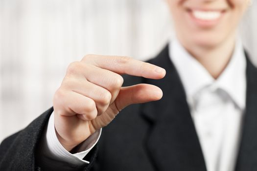 Beauty smiling business woman showing pinch finger sign