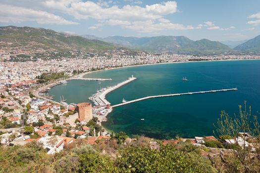 Summer vacations - blue Mediterranean sea and Turkey Alanya east coast beach resort with lighthouse and ship bay view from ancient mountain castle wall