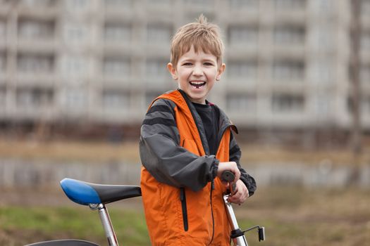 Little smiling child boy cycling sport bicycle outdoor