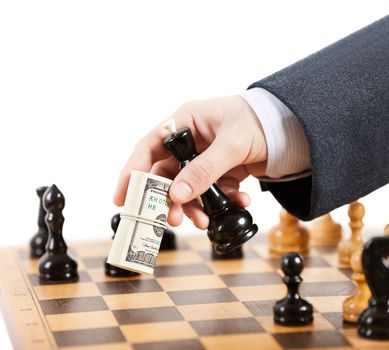 Business man hand holding dollar currency unfair playing chess game