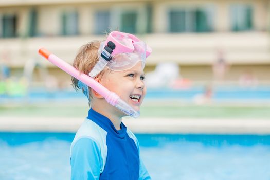 Boy playing in a pool of water during the summer