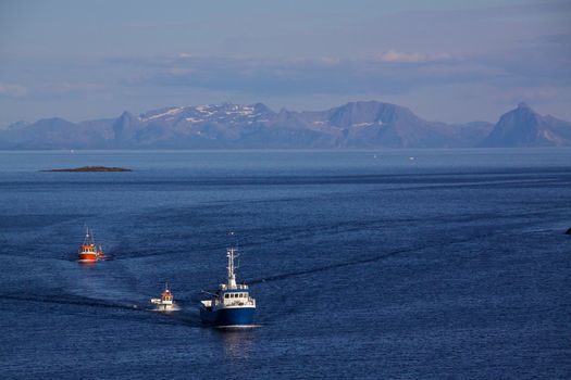 Fishing boats returning to port in Henningsvaer on Lofoten Islands, Norway