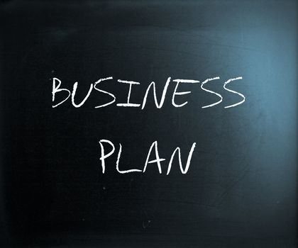 "Business plan" handwritten with white chalk on a blackboard.