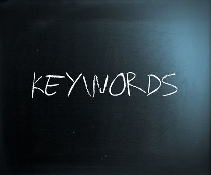 "Keywords" handwritten with white chalk on a blackboard.
