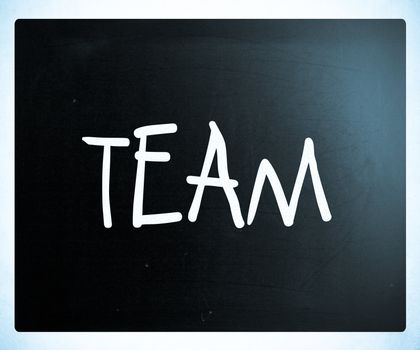 The word "TEAM" handwritten with white chalk on a blackboard