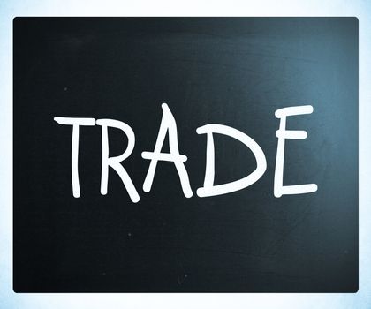 "Trade" handwritten with white chalk on a blackboard