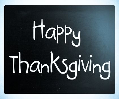 "Happy Thanksgiving" handwritten with white chalk on a blackboard