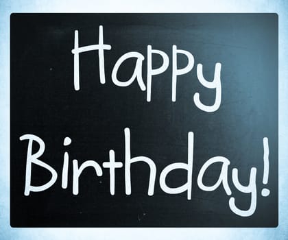 "Happy Birthday" handwritten with white chalk on a blackboard