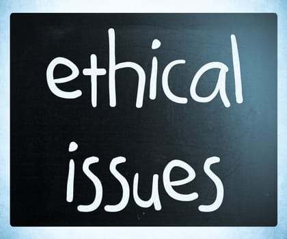 "Ethical issues" handwritten with white chalk on a blackboard