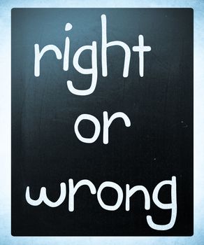 "Right or wrong" handwritten with white chalk on a blackboard