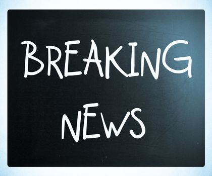 "Breaking news" handwritten with white chalk on a blackboard