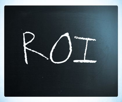 The word "ROI" handwritten with white chalk on a blackboard.