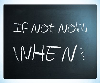 "If not now, when?" handwritten with white chalk on a blackboard.