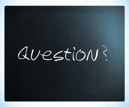 "Question" handwritten with white chalk on a blackboard.