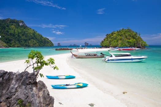 boats and the clear sea Phi Phi south of Thailand