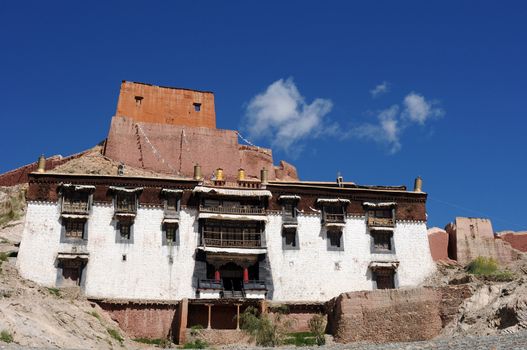 Landmark of typical historic Tibetan buildings against blue sky