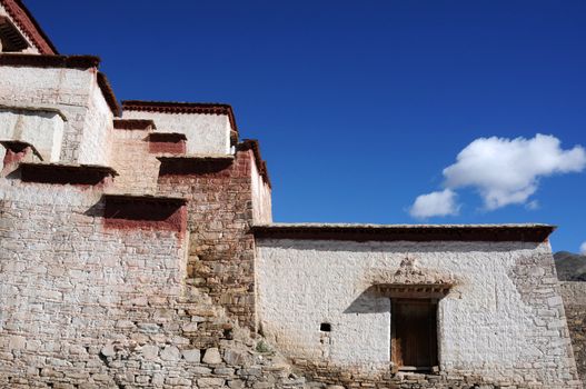 Landmark of typical historic Tibetan buildings against blue sky