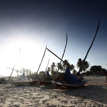 fishing boats stay on ground sunset sky