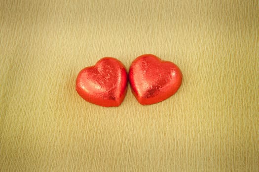 Chocolate heart shaped cookies on brown background