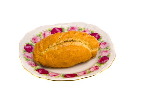 Karaite pastry stuffed with chopped lamb in decorative flower dish isolated on white background.