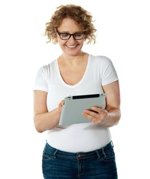 Glamorous lady using her tablet pc isolated over white background