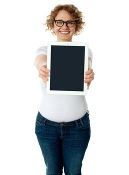 Woman showing tablet screen to camera. Isolated on white