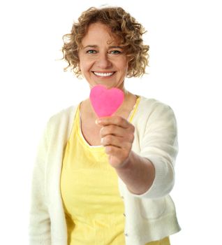 Happy woman offering her heart. Isolated on white