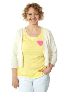 Attractive woman posing with pink paper heart on her t-shirt
