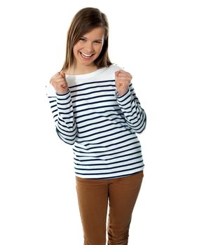 Excited sweet smiling teenager in trendy outfit