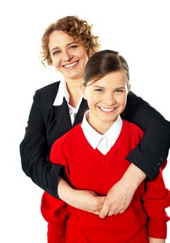 Teacher embracing her student from back and posing in front of camera