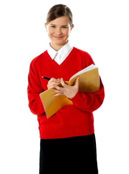 Little caucasian student school girl writing on her notebook isolated over white background