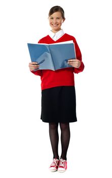 Caucasian smiling student girl standing with exercise book