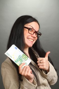 the girl the brunette wearing spectacles holds a roll of money