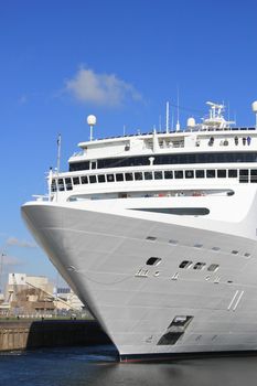 Big cruiseship in a canal, sailing towards the sea