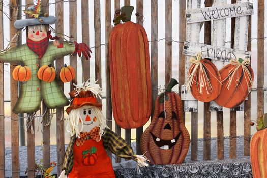 Display of seasonal autumn crafts including scarecrows and pumpkins 