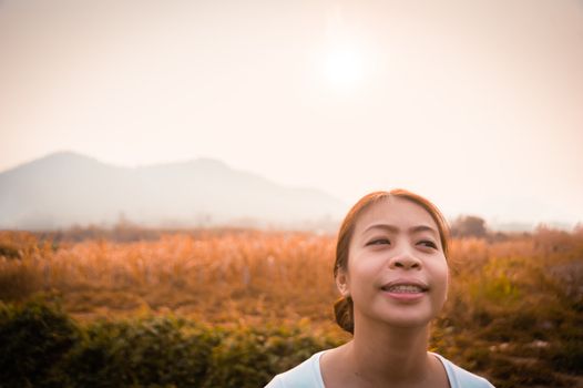 asian woman in field in morning time with sunlight