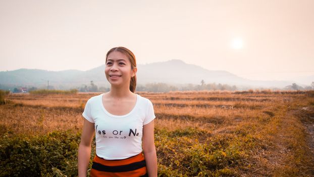 asian woman in field in morning time with sunlight