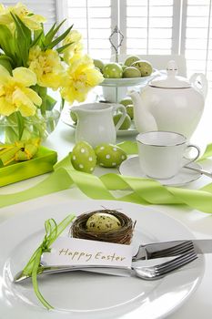 Place setting with card and flowers for easter brunch