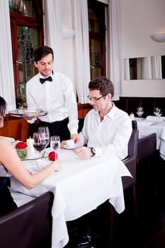 waiter serve fresh espresso for happy couple in restaurant