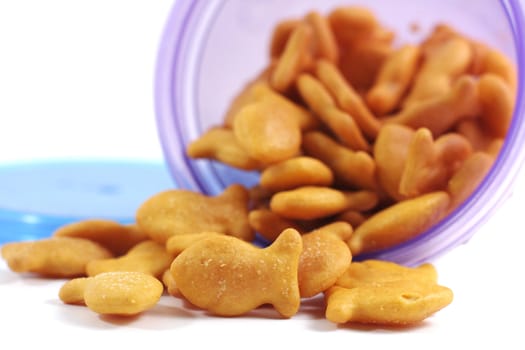 Goldfish crackers spill out from a child's snack cup