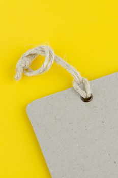 Closeup of blank product info label on yellow background.