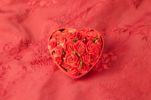 Valentine's day box rose on red fabric