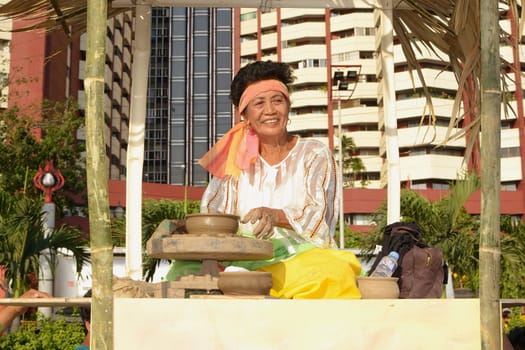 MANILA, PHILIPPINES - APR. 14: parade contestant making clay pot during Aliwan Fiesta, which is the biggest annual national festival competition on April 14, 2012 in Manila Philippines.