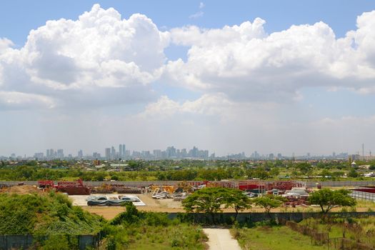 elevated view of a city skyline with industrial equipment at the frontview.