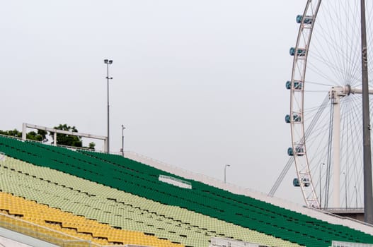 A view of Singapore flyer and colourful tribunes of the stadium at the marina