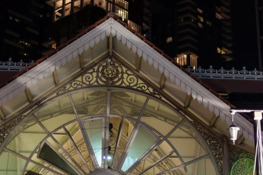 singapore - beautiful colonial architecture of old market foodcourt in front of modern skyscrapers