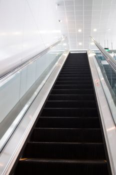 Modern escalator moving up with bright colours