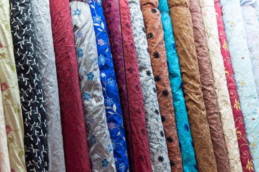 Large amount of fabric bolts on stacks in the arabic quarter of singapore