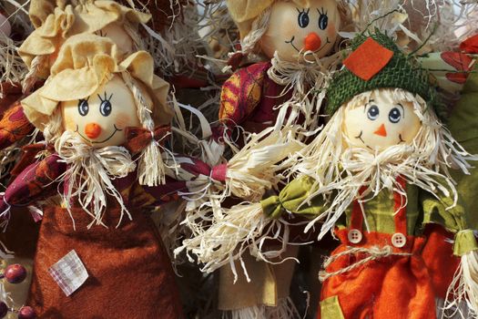 A colorful arrangement of Halloween scarecrow dolls welcome the fall autumn season